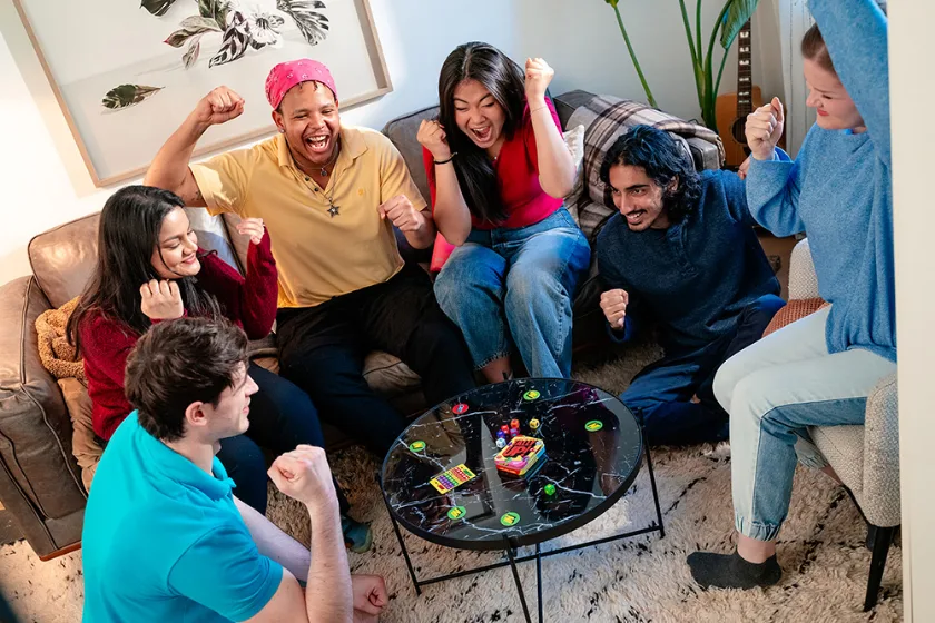 Friends cheering around a game of Tally Up